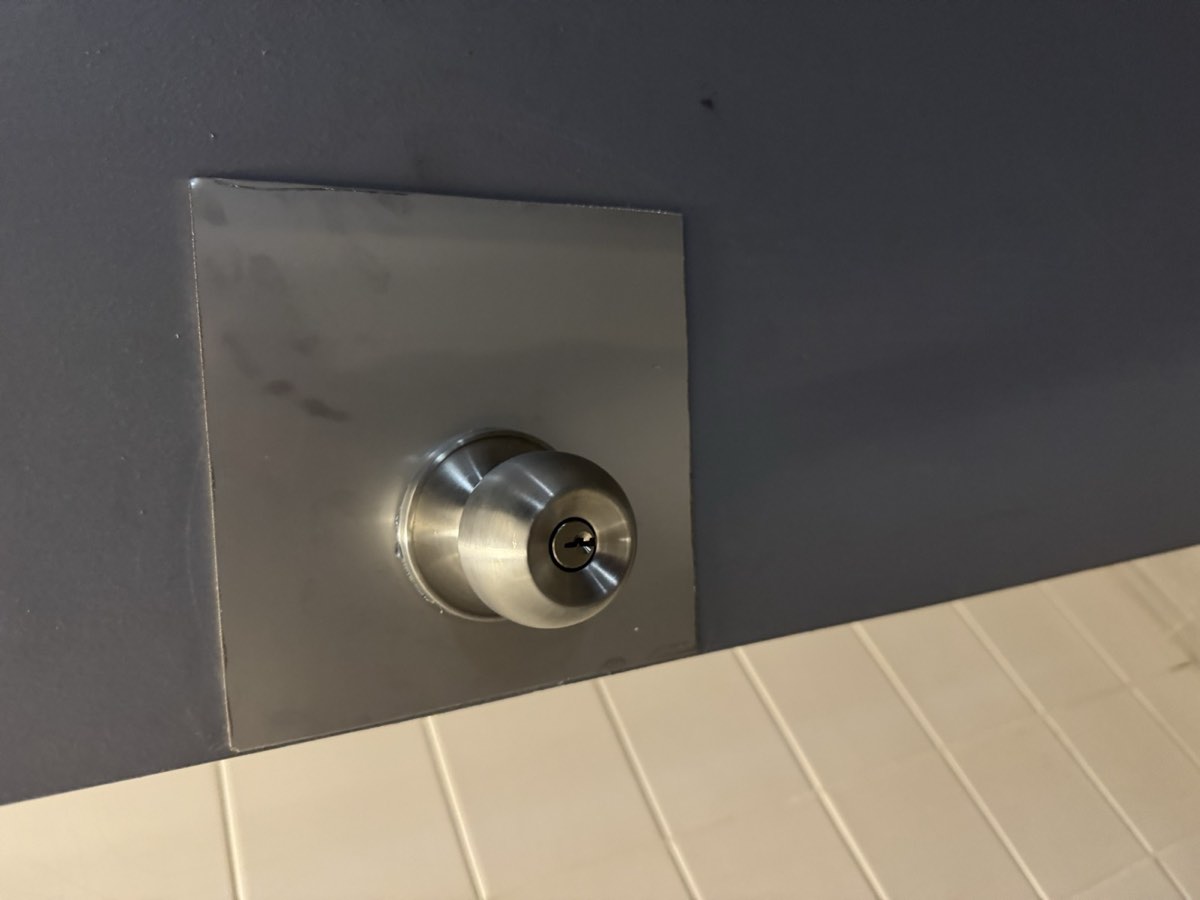 Door lock and knob on a steel plate